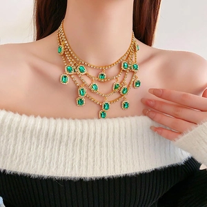 Detail of emerald emerald green tassel necklace with sparkling rhinestones on neck