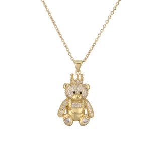 Detailed close-up of a gold-plated bear pendant with a crown and sparkling gemstones