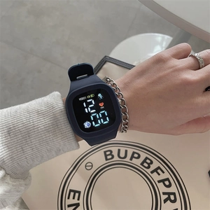 Close-up of LED sports watch showing time and heart rate data on a dark silicone strap