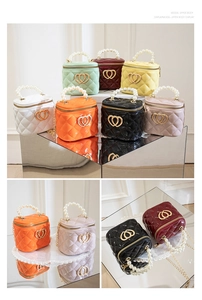 Detail of quilted mini bucket bags featuring pearl handles and golden heart-shaped clasps