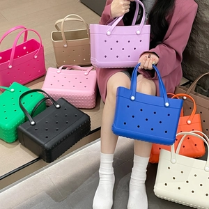Macro view of colorful EVA tote bags with iconic perforated holes in multiple shades