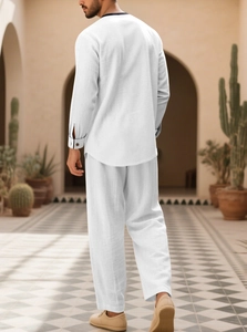 Detail view of men's white linen long-sleeve shirt and pants set with relaxed texture