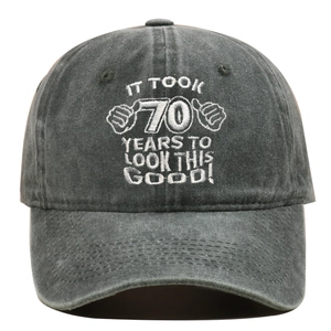 Detail of embroidered 70th birthday text on washed grey cotton baseball hat