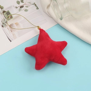 Close-up of a red plush star ornament with a gold hanging string for bags and keys