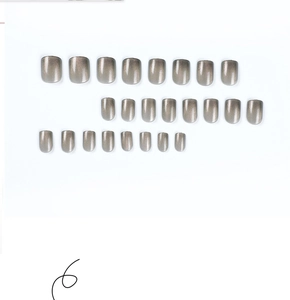 Detailed flat lay of 24pcs grey cat-eye press-on nails in various sizes with silk texture