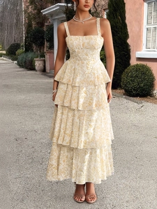 Close-up of tiered ruffle hem and yellow floral print on white chiffon maxi dress