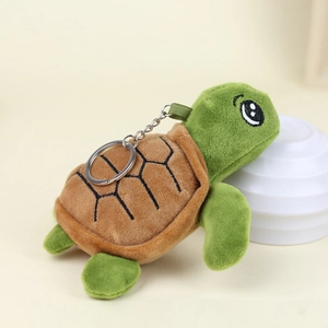Close-up of green turtle plush keychain with soft fabric texture and metal ring
