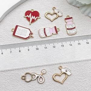 Detail of medical charms set with ruler showing size of nursing hat and medicine bottle