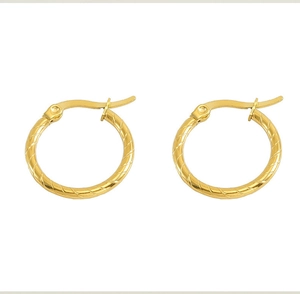 Detailed view of gold hoop earrings with diagonal texture and lever back closure