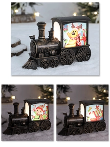 Close-up of vintage bronze LED Christmas train lanterns with Santa and elk patterns
