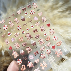 3D embossed nail stickers featuring brown puppy, coffee, and strawberry cake motifs