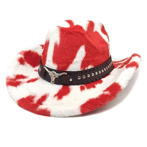 Detail of red and white cow print cowboy hat with plush texture and silver bull head buckle