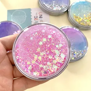 Foldable glitter liquid quicksand makeup mirror in round shape with pink sparkles