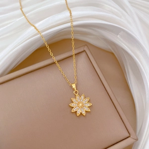 Elegant gold titanium steel daisy necklace with sparkling crystals on a silk background