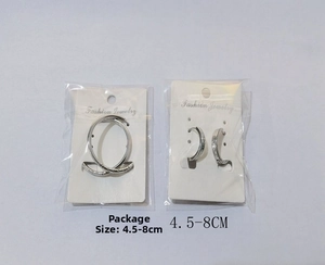 Detailed view of silver titanium steel earrings with intricate engraved patterns on display