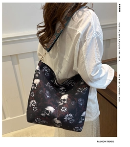 Detail of skull print tote bag with vintage ethnic strap on model back view