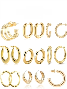Detailed grid of assorted gold titanium steel hoop earrings in various geometric styles