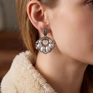 Vintage style silver needle earrings with radiant pearls and shimmering diamonds