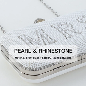 Close-up of the white pearl and rhinestone MRS lettering on the wedding clutch bag