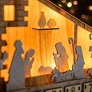Macro view of LED wooden nativity advent calendar with warm lighting and detailed carvings