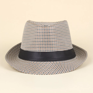 Macro view of houndstooth weave texture and black satin ribbon on gentleman fedora