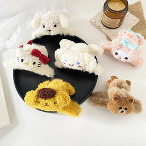 Macro detail of various soft plush cartoon character hair claws on a round display tray