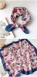 Detail view showing artistic floral print and lightweight semi-sheer texture of the scarf