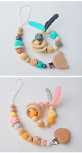 Detail of wooden and silicone pacifier clips with crochet beads and animal shapes