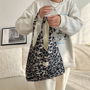 Detailed shot of large leopard print canvas tote bag with white patch and sturdy lining