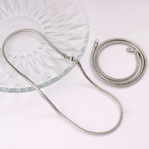 Close-up of silver stainless steel foxtail chain with a secure lobster clasp closure