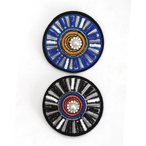 Detailed view of handmade beaded Evil Eye brooches with crystal rhinestones and pearls