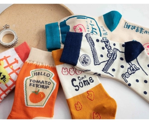 Flat lay of colorful mid-calf cotton socks with cute cartoon food illustration patterns