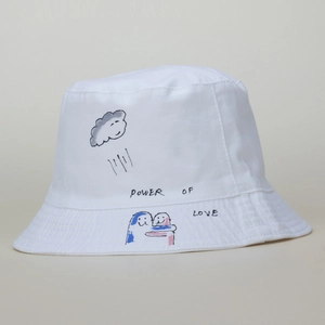 White canvas bucket hat with Power of Love hand-drawn illustration and sun protection