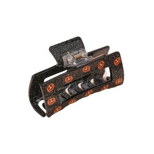 Minimalist square Halloween claw clip featuring a black resin finish and orange pumpkin patterns