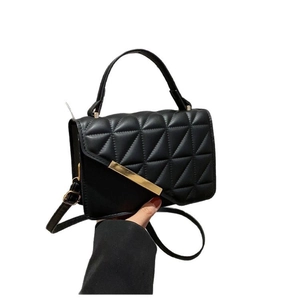 Chic black quilted handbag with gold hardware and a detachable shoulder strap for women