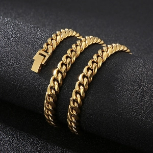 Close-up of a polished gold Cuban link bracelet with a secure clasp on dark background