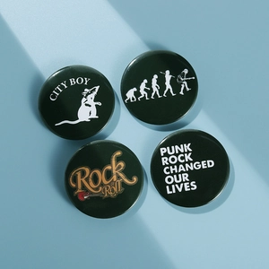 Detailed view of four dark green tinplate badges with punk rock and guitar motifs