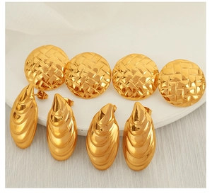 Detail of gold woven texture stud earrings set on a white minimalist platform