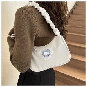 Detail of white nylon shoulder bag with heart rabbit embroidery and gathered strap