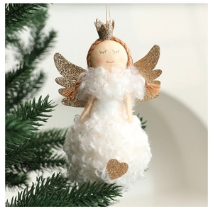 Macro shot of plush angel doll with golden wings and sequins on a Christmas tree branch
