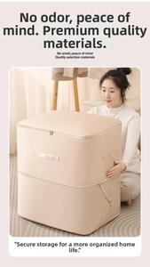 Detail showing reinforced stitched handles and dual zipper on beige satin storage bag