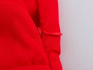 Detailed close-up of a red sleeveless dress featuring a seamless invisible zipper closure