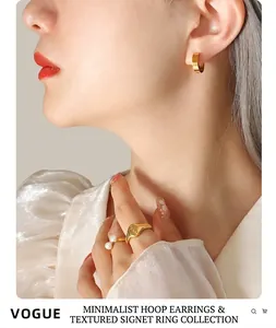 Detail of gold-plated hoop earrings and rings set with pearls in vintage style