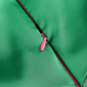 Detail of high-quality invisible pink zipper on green bodycon fishtail evening dress