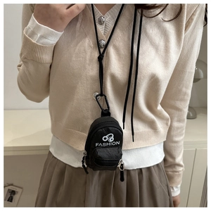 Close-up of black nylon mini backpack pouch with white headphone logo and neck lanyard