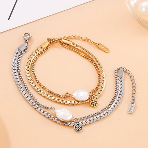 Double-layered stainless steel bracelet with baroque pearl and cross pendant in gold and silver