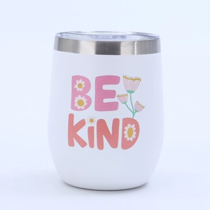 Close-up of 12oz stainless steel egg tumbler with 'BE KIND' floral lettering and clear lid