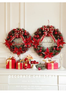 Christmas wreath with red flowers and Merry Christmas sign hanging on white vintage wall