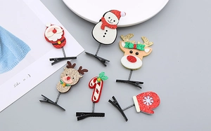 Détail de pinces à cheveux de Noël pailletées avec Père Noël, renne et bonhomme de neige