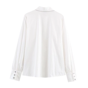 White long-sleeved poplin shirt with beaded chain detail on the back collar and wide cuffs